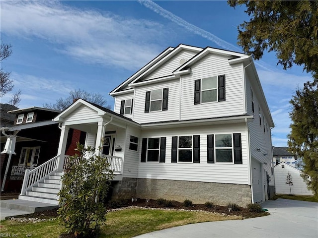 traditional-style house featuring a porch and driveway