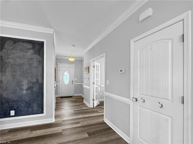 entrance foyer with crown molding and dark hardwood / wood-style flooring