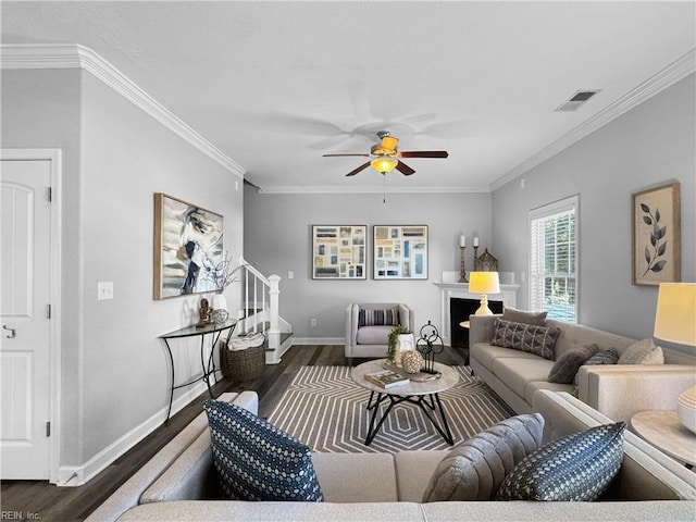 living room featuring ceiling fan, ornamental molding, and dark hardwood / wood-style floors