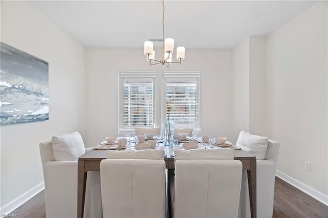 dining area with a chandelier and dark hardwood / wood-style floors