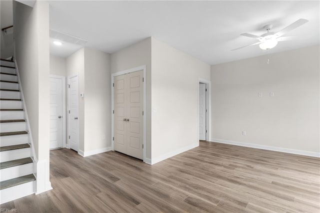 empty room with light hardwood / wood-style flooring and ceiling fan