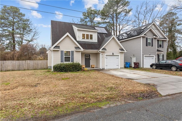 view of front of property with a front lawn, solar panels, and a garage