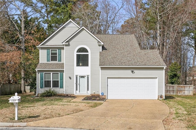 view of front property featuring a garage and a front lawn