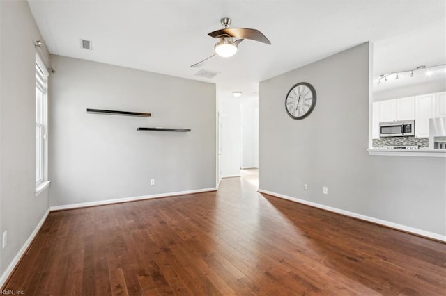 unfurnished living room featuring ceiling fan and hardwood / wood-style floors