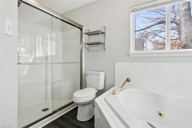 bathroom featuring toilet, hardwood / wood-style floors, and shower with separate bathtub