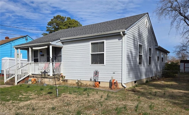 bungalow-style house with a porch, a front yard, and a shingled roof