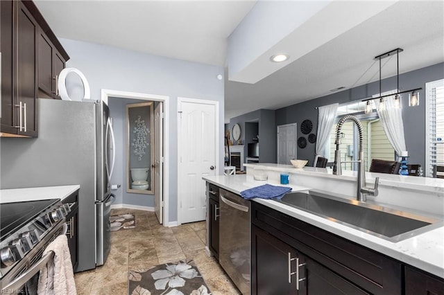 kitchen featuring sink, stainless steel appliances, dark brown cabinetry, and hanging light fixtures