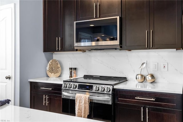 kitchen featuring stainless steel appliances, decorative backsplash, and dark brown cabinetry