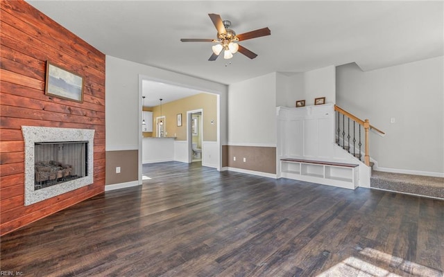 unfurnished living room with ceiling fan and dark hardwood / wood-style floors