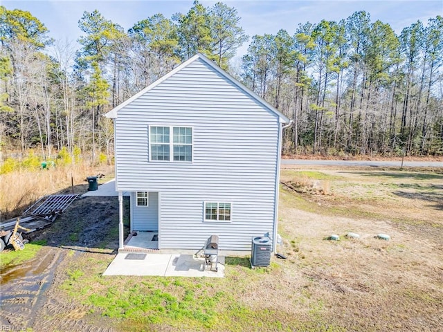 back of property featuring a patio area, a yard, and central AC unit