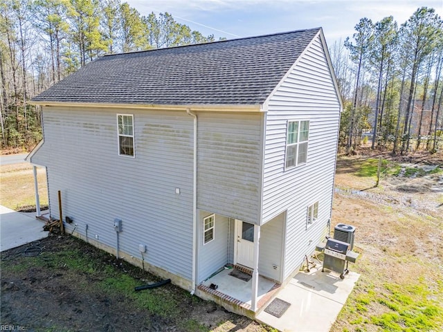 view of side of home with central AC unit