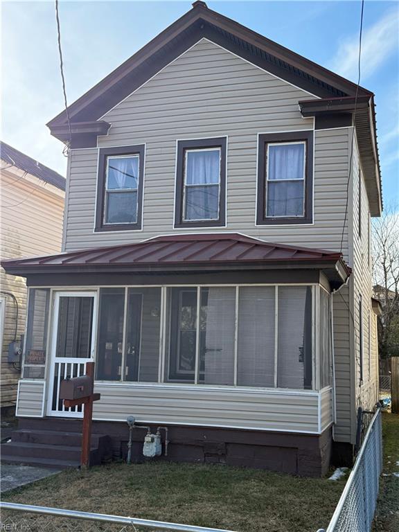 rear view of property with a sunroom