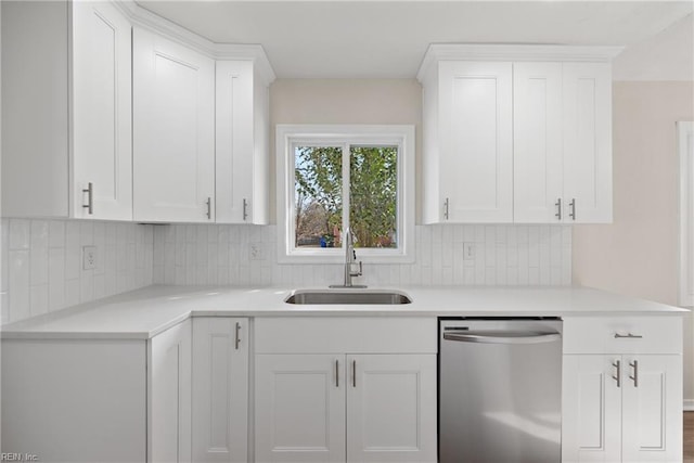 kitchen with white cabinetry, sink, backsplash, and stainless steel dishwasher