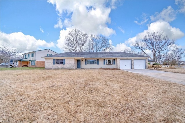 ranch-style house with concrete driveway, a front lawn, and an attached garage