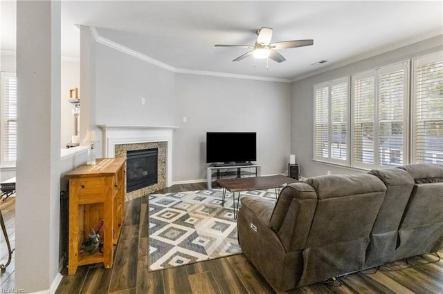 living room with dark wood-style floors, a high end fireplace, and ornamental molding