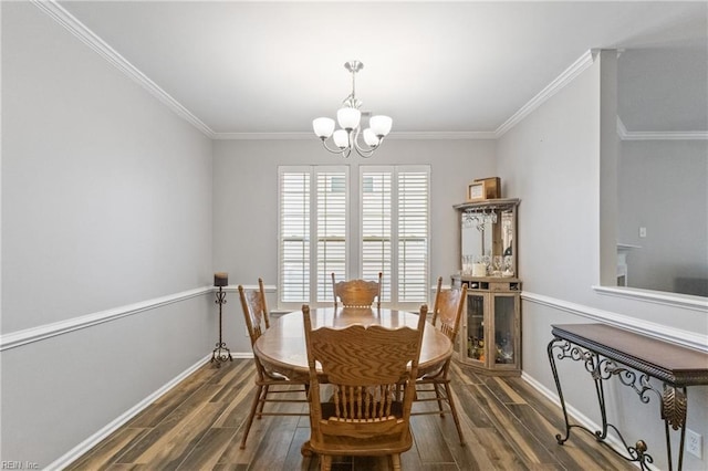 dining room with a chandelier, crown molding, and dark wood finished floors