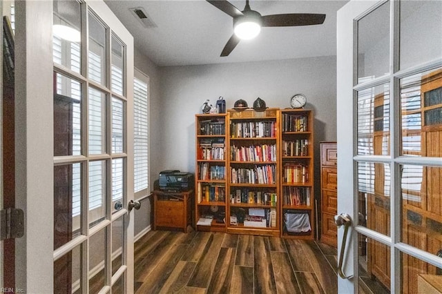 living area with a ceiling fan, visible vents, dark wood-type flooring, and french doors