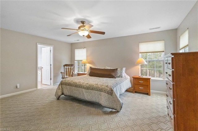 bedroom featuring baseboards, visible vents, and light colored carpet