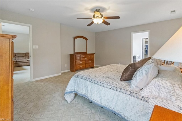 bedroom with baseboards, visible vents, a ceiling fan, and light colored carpet