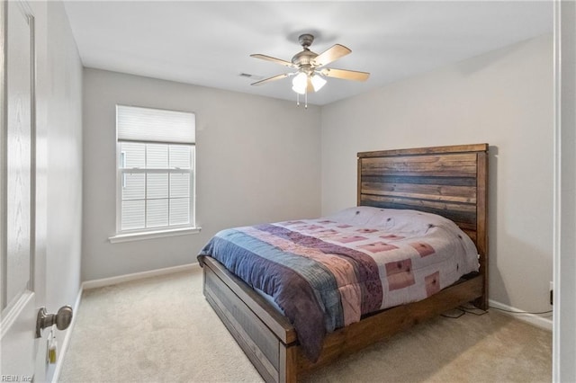 bedroom with light carpet, visible vents, baseboards, and a ceiling fan