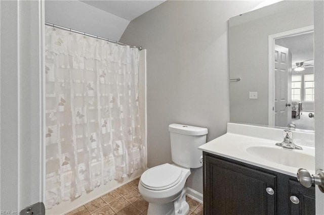 full bathroom featuring toilet, lofted ceiling, tile patterned flooring, shower / bath combo with shower curtain, and vanity