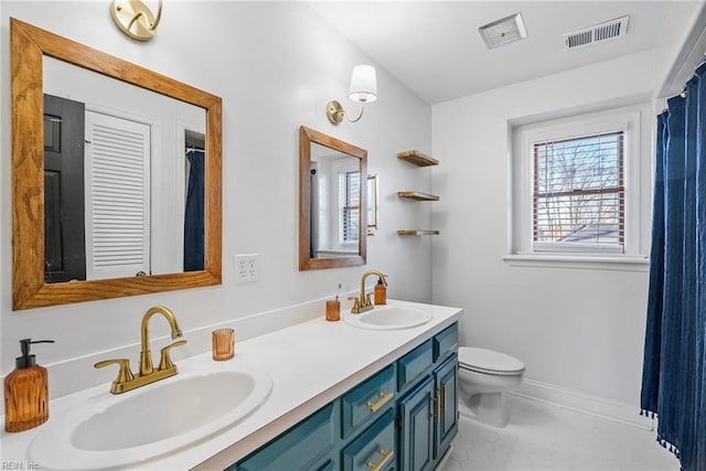 bathroom featuring vanity and toilet