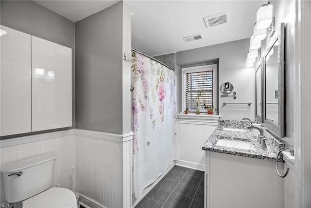 bathroom with toilet and vanity