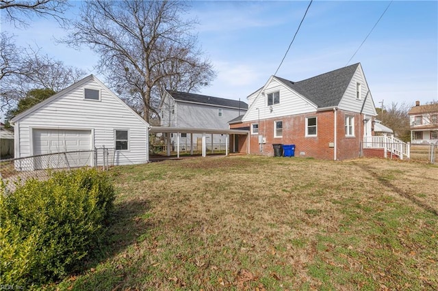 view of yard with a garage and an outbuilding