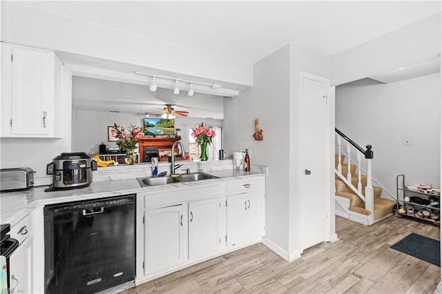 kitchen with sink, white cabinetry, light hardwood / wood-style floors, and dishwasher