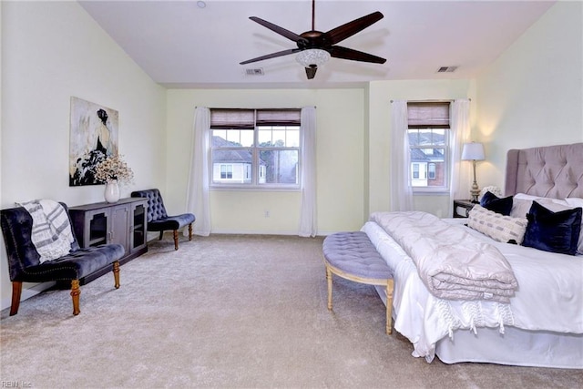 bedroom featuring light carpet, ceiling fan, visible vents, and baseboards