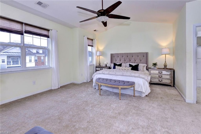 bedroom featuring light carpet, multiple windows, lofted ceiling, and visible vents