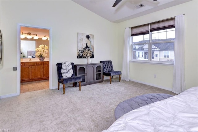 bedroom featuring lofted ceiling, visible vents, light carpet, connected bathroom, and baseboards