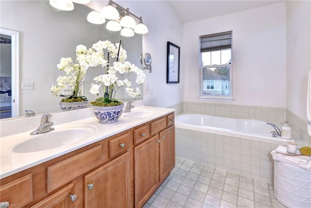 full bath featuring double vanity, a sink, and a bath