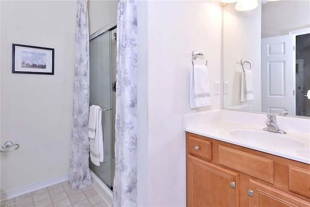 full bathroom with baseboards, a shower stall, vanity, and tile patterned floors