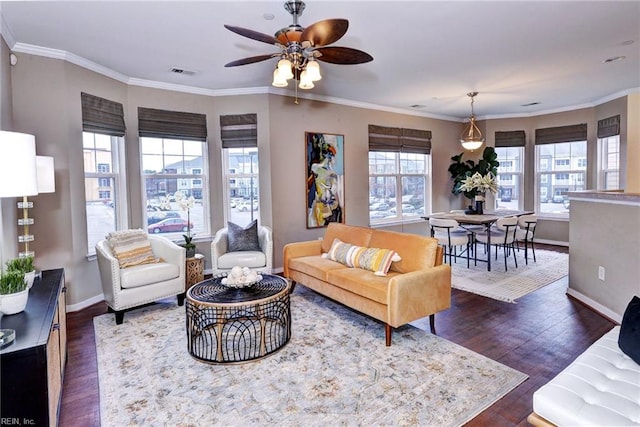 living room featuring ornamental molding, dark wood-style flooring, visible vents, and baseboards