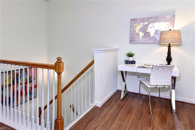 office area with dark wood-style flooring and baseboards