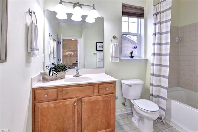 bathroom with toilet, shower / tub combo, baseboards, and vanity