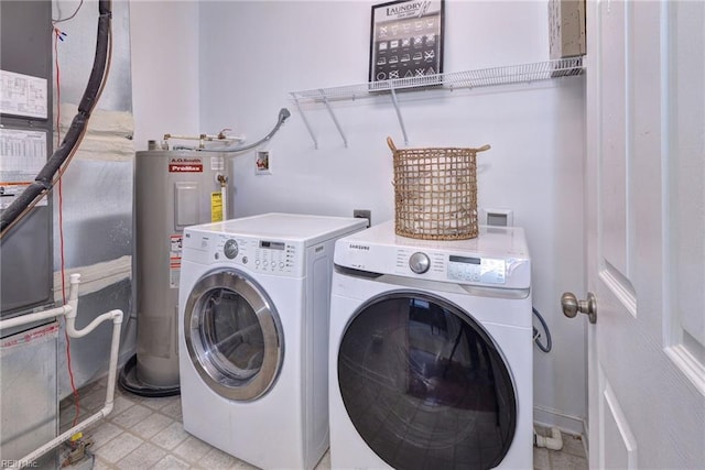 laundry area featuring laundry area, light floors, electric water heater, and washer and dryer