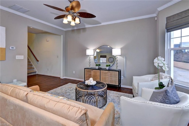 living room with dark wood-style floors, stairs, baseboards, and crown molding