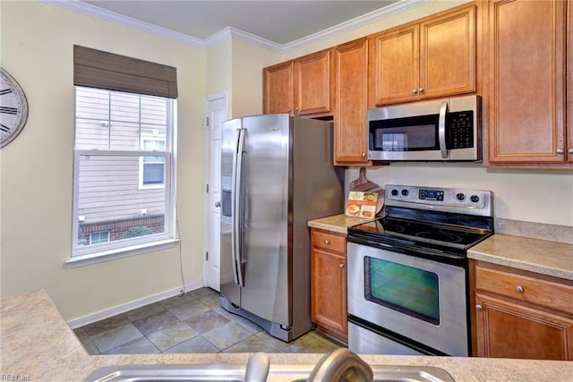 kitchen with stainless steel appliances, brown cabinets, light countertops, and crown molding