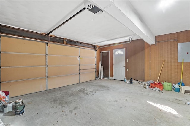 garage with electric panel and a garage door opener