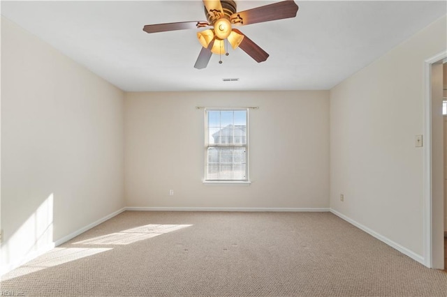 empty room with ceiling fan and light carpet