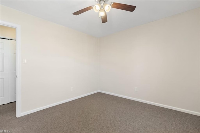 carpeted spare room featuring ceiling fan