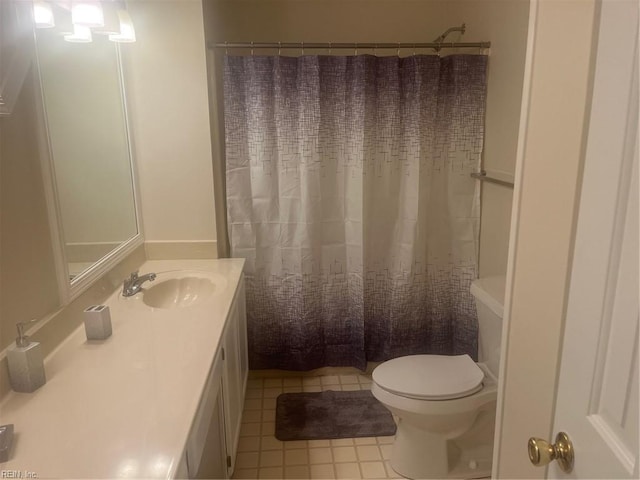 bathroom featuring toilet, vanity, and curtained shower