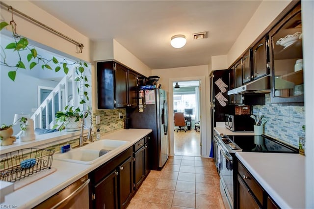 kitchen featuring visible vents, appliances with stainless steel finishes, light countertops, dark brown cabinets, and a sink