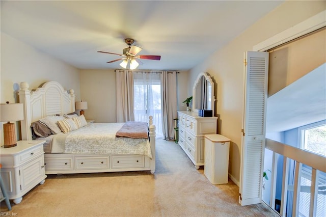 bedroom with light carpet, baseboards, and a ceiling fan