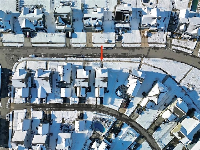 snowy aerial view featuring a residential view