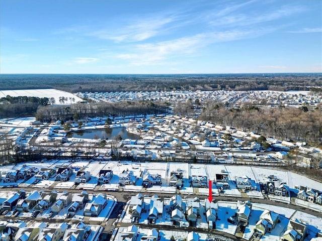 snowy aerial view with a residential view