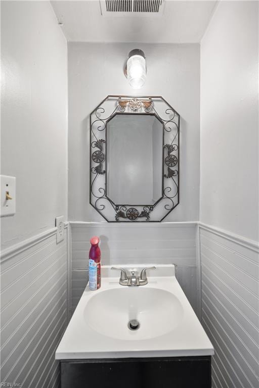 bathroom with tile walls and vanity