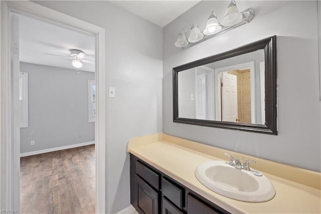 bathroom featuring hardwood / wood-style flooring, ceiling fan, and vanity